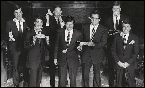 Despite the pressures at Bain Capital, Mitt Romney kept the atmosphere loose. One year, after posing for a photo for a firm brochure, the partners did another take, the second time holding $10 and $20 bills. From left, Fraser Bullock, Eric A. Kriss, Joshua Bekenstein, Mitt Romney, Coleman Andrews, Geoffrey S. Rehnert, and Robert F. White.