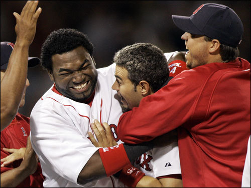'Maybe they were looking down on us from up above,' said Lowell, center, being mobbed by teammates David Ortiz, left, and Josh Beckett after the game. 'You never know.'