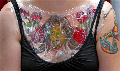 The plastic wrap protects new tattoos from infection. (Globe Staff Photo 