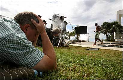 Jerry Cronin (above), an ad co-creator for MMB, keeps his head down to stay out of window reflections the video camera may pick up while filming a Subway commercial in Slidell, La. In the background, New Orleans Saints running back Reggie Bush walks down the steps of a pool. In photo below left, Bush and Jared Fogle prepare for another scene.
