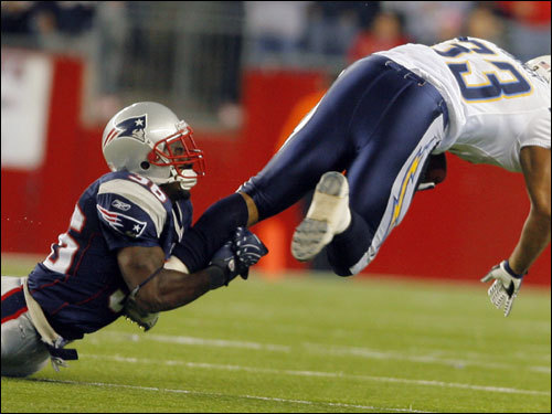Patriots defensive back James Sanders took down San Diego Chargers running back Michael Turner during the first half.