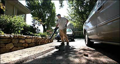Landscaper Ian Cura used a leaf blower for a job in Newton on Friday. An alderman wants to outlaw gas-powered blowers.