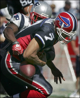 Patriots cornerback Ellis Hobbs (rear) sacked Buffalo quarterback JP Losman, causing Losman to fumble.