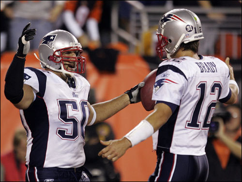 Patriots linebacker Mike Vrabel (left) who lined up on offense, celebrated with Pats QB Tom Brady (left) after receiving a touchdown pass in the first quarter.
