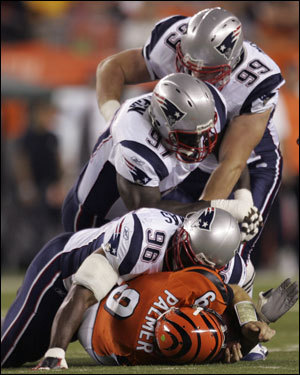 Pats LB Adalius Thomas (96) laid atop Bengals quarterback Carson Palmer after a sack in the first quarter.
