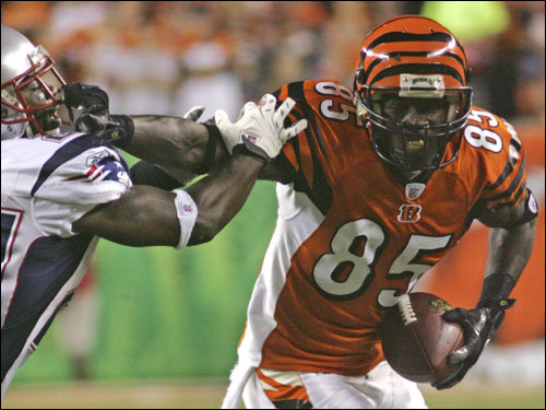 Bengals wide receiver Chad Johnson (right) avoided a tackle from the Patriots Ellis Hobbs (left) on his way to the 1-yard line. The Bengals scored on the next play.