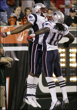 Randy Moss (left) and Donte Stallworth (18) celebrated following Moss's second touchdown grab of the game.