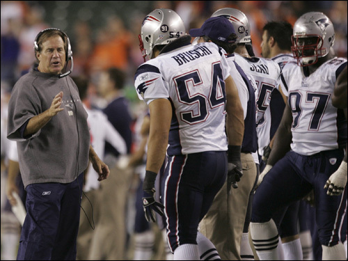 Bill Belichick talked with his defense, including Ted Bruschi (54).