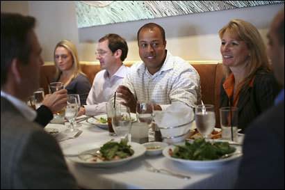 Troy Jackson (center), and Gitti Crowley interact with other HiWired executives during a recent lunch.