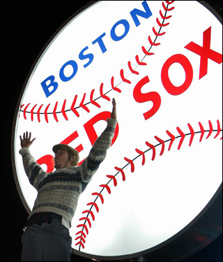 A fan celebrated on a billboard outside Fenway Park in Boston after the Red Sox defeated Colorado in Game 4 of the World Series.