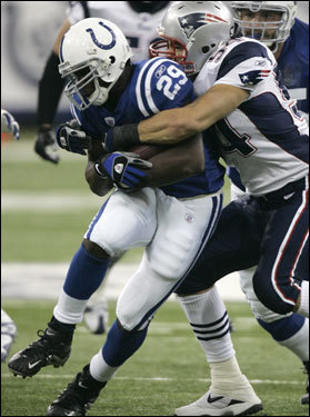 Patriots linebacker Tedy Bruschi (right) tackled Colts running back Joseph Addai (29) in the first quarter.