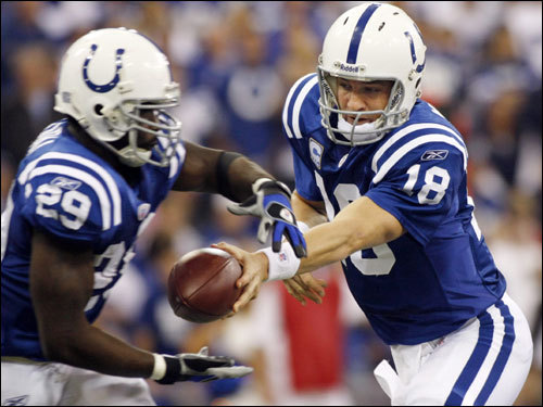 Colts quarterback Peyton Manning (right) handed the ball off to Joseph Addai (left) during the first half.