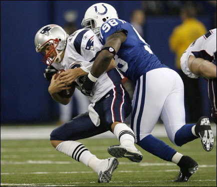 Roger Mathis (right) sacked Tom Brady (left) in the first quarter.