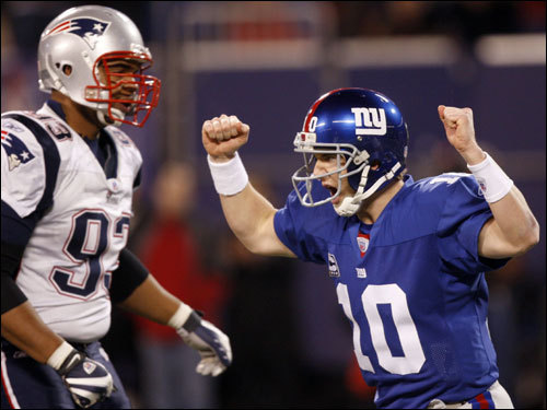 Eli Manning (right) celebrated a touchdown by the Giants late in the first half.