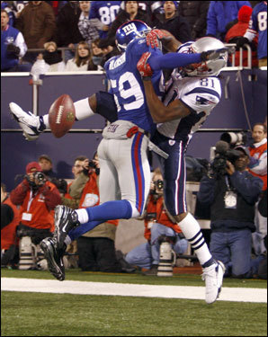 Gerris Wilkinson (59) was flagged for pass interference against Randy Moss (81) in the third quarter.