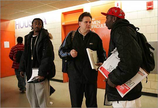 Jack O’Brien talked with Jason “Hood” White, holding an application for Adelphi University, while White’s teammate Ridley Johnson listened in.