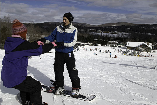 Allegra Carignan of Brattleboro, Vt., got some tips last week from Francisco Vilcher of Los Andes, Chile, during a snowboarding class at Mount Snow, Vt.