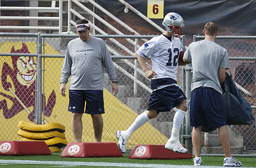A taped right ankle didn't stop Brady from running drills during practice