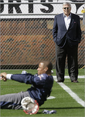 Patriots owner Robert Kraft watched the team practice as safety Rodney Harrison stretched.