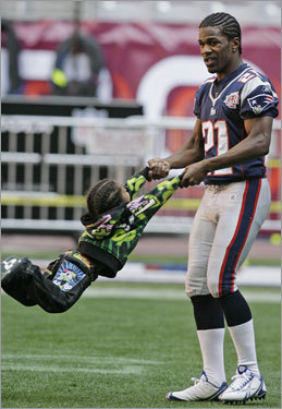 Patriots cornerback Randall Gay (21) swings his son Randall Gay III.