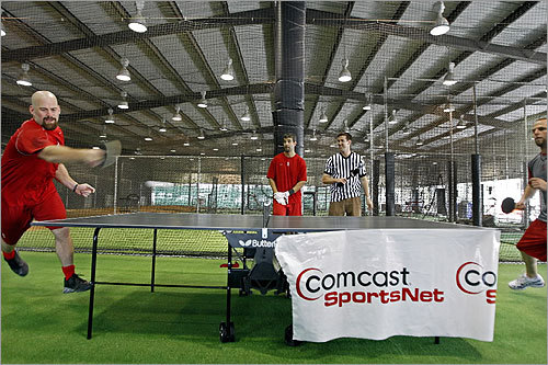 In an unofficial spring training event, Kevin Youkilis (left), Mike Lowell (center), and Dustin Pedroia (right) competed in a round robin ping-pong tournament, presented by Comcast SportsNet.