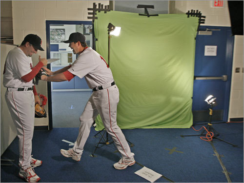Josh Beckett (right), who had been trying to record some video in front of the green backdrop, suddenly jumped out of the frame and shoved teammate Doug Mirabelli (left), who had been harrassing him off camera.