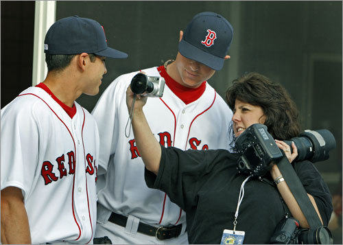 Photographer Rhona Wise showed Jon Lester (center) a photo she took with a fisheye lens. Jacoby Ellsbury is at left.