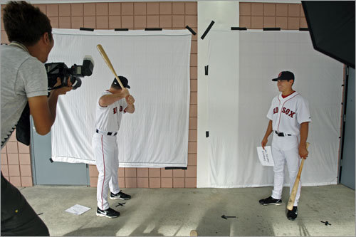 J.D. Drew (left) had some fun when a photographer asked him to pose in his batting stance, and Drew turned around and faced the wall. Teammate Jacoby Ellsbury waited for his turn at right.