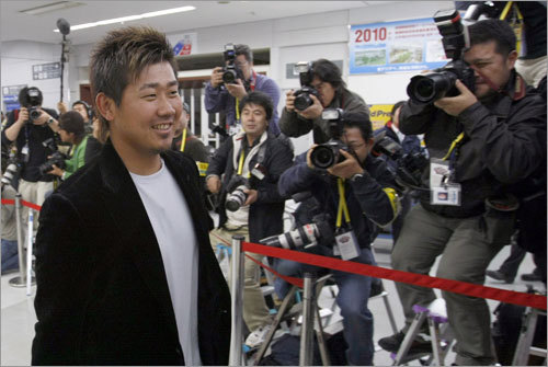 Red Sox pitcher Daisuke Matsuzaka (left) arrives at Tokyo's Haneda airport March 21, 2008. The Boston Red Sox flew into Tokyo on Friday, arriving just after midnight.