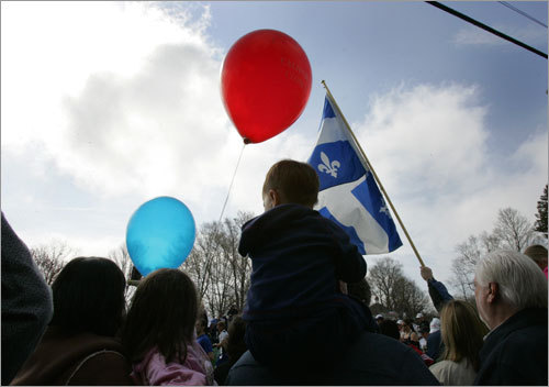 Race fans held up balloons near the start line of the 112th Boston Marathon.