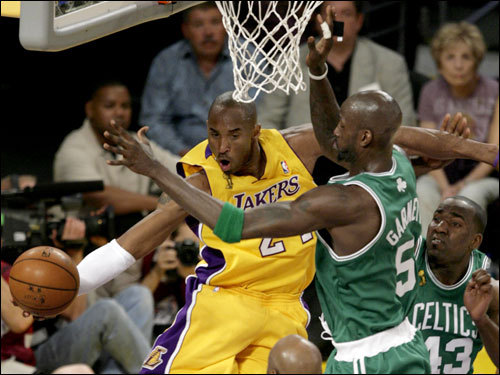 Kobe Bryant (left) was defended by Kevin Garnett (right) underneath the hoop during first half action.