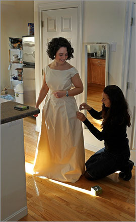 Deifik tries on her wedding dress in March at her home with the help of gown designer Laura Coulter.