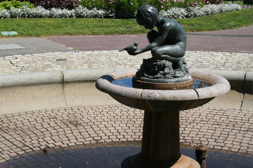 Right next to the boy on the rock is another of the four fountains of a girl holding a bird, but this fountain is empty. This is another of Boston's noncirculating fountains.
