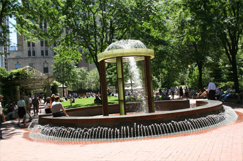 At a popular relaxing spot in the Financial District, workers clad in ties and slacks ate their lunches on top of a parking garage. Norman B. Leventhal Park, which is maintained financially by the Garage at Post Office Square beneath it, boasts a sculptural fountain centerpiece where workers come to dangle their toes in the walk-through stream of water during breaks from the office.