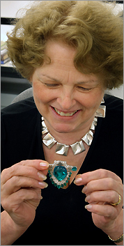 MFA jewelry curator Yvonne Markowitz holds a brooch once owned by cereal heiress Marjorie Merriweather Post.