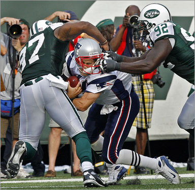Cassel has his face mask grabbed and his helmet almost torn off his head by the Jets Shaun Ellis (92). The penalty on the second quarter, third down play gave New England an automatic first down.