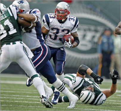 The Patriots' Kevin Faulk leaves the Jets' Cody Spencer on his back and looking up at him as he blows by the linebacker.