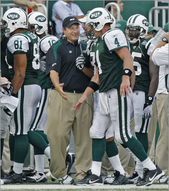 Jets quarterback Brett Favre (right) gets a hand from head coach Eric Mangini after his touchdown pass to WR Chansi Stuckey (not pictured).