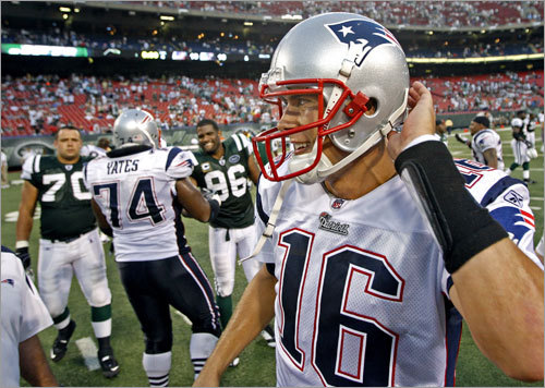 Cassel cracks a smile as he surveys the scene on the field following the final play of the game. The Patriots' Billy Yates shakes hands with the Jets' Davis Bowens in the backround at left. Jets offensive lineman Mike DeVito (70), who went to college at Maine, is at far backround left.
