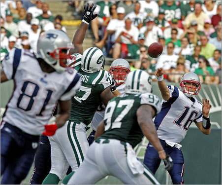 Patriots quarterback Matt Cassel throw a pass as wide reciver Randy Moss (81,far left) breaks on a route.
