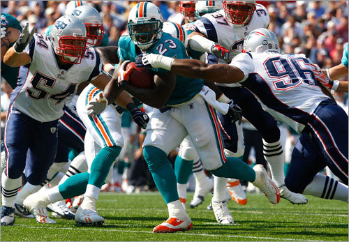 Ronnie Brown drags several Patriots with him as he scores one of his three first-half touchdowns.