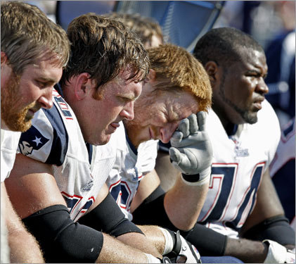 Patriots offensive linemen (left to right) Matt Light, Logan Mankins, Dan Koppen and Billy Yates sit on the bench during the fourth quarter.