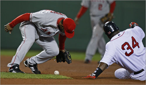 Red Sox DH David Ortiz slid into second safely as Howie Kendrick (left) dropped an errant throw from third baseman Chone Figgins.