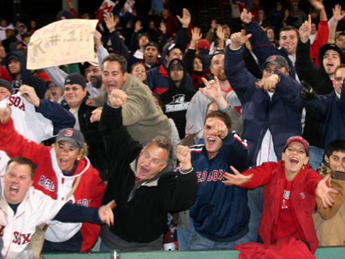 Fans behind the Red Sox dugout let loose during the postgame celebration Monday night.