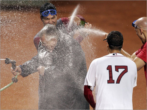 Red Sox relief pitchers doused Boston police detective William Dunn outside of the bullpen during celebrations.