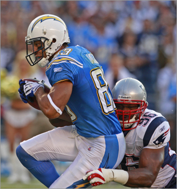 Adalius Thomas tries to put the brakes on Chargers wide receiver Vincent Jackson, who led San Diego with four catches for 75 yards and a TD in the first half. Click through to see more photos of Sunday night's Patriots-Chargers tussle.