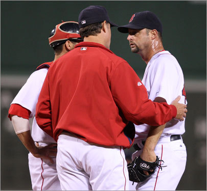 Red Sox catcher Jason Varitek (left), pitching coach John Farrell (center), and pitcher Tim Wakefield (right) had a conference on the mound in the first inning.