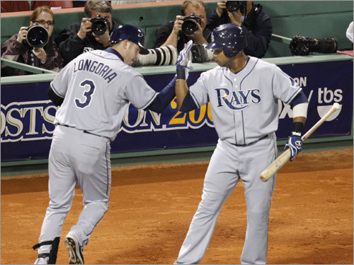 Rays third baseman Evan Longoria (left) celebrated with Willy Aybar (right) after his solo home run in the first inning.