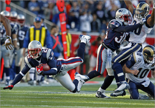 Patriots cornerback Delthea O'Neal flies through the air as he is brought down an interception.