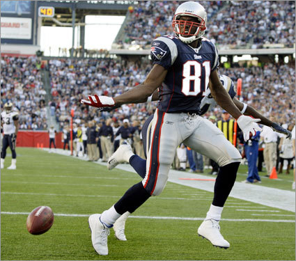 Patriots receiver Randy Moss (81) gestures to the ref as the ball bounced away after Rams cornerback Fakhir Brown (hidden behind) broke up a pass intended for Moss during the fourth quarter.